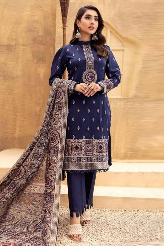 Woman wearing a navy blue traditional outfit with a patterned dupatta against a beige background