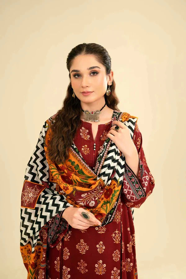Woman wearing a traditional outfit with a colorful shawl against a beige background